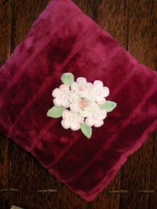 Purchased pillow with crochet flowers
