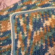 Carol made this blanket with blue and brown yarn.