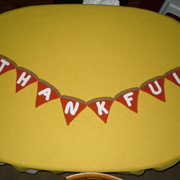 Dody crocheted a pumpkin pie banner that says "thankful".