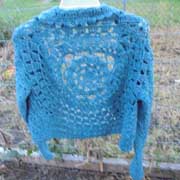 Daelynn finished this lacy blue cardigan sweater.