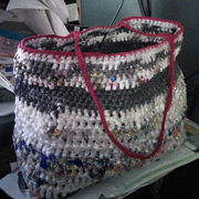 Penny is almost done with her plarn (plastic yarn) bag.