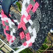 Debbie made this weaved scarf in pink, black, and white.