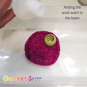 Adding the Wool Wash to the Basin on How to Launder Your Crocheted Items by Caissa McClinton @artlikebread on @crochetspot